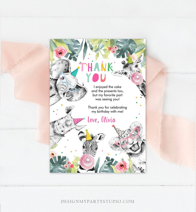May include: Thank you card with a jungle animal theme. The card features a zebra, giraffe, elephant, and rhino wearing party hats. The text on the card reads "Thank You" and "I enjoyed the cake and the presents too, but my favorite part was seeing you! Thank you for celebrating my birthday with me! Love, Olivia."