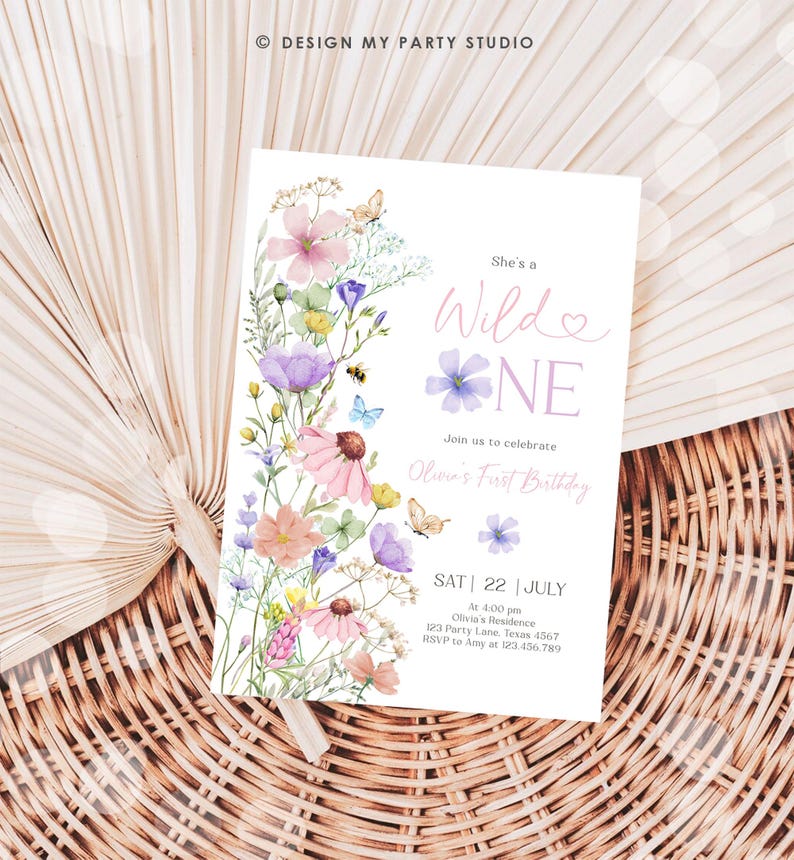 May include: A floral-themed first birthday party invitation with a watercolor design featuring pink, purple, and yellow flowers. The text reads "She's a Wilde One" and includes details for the party, including the date, time, location, and RSVP information.