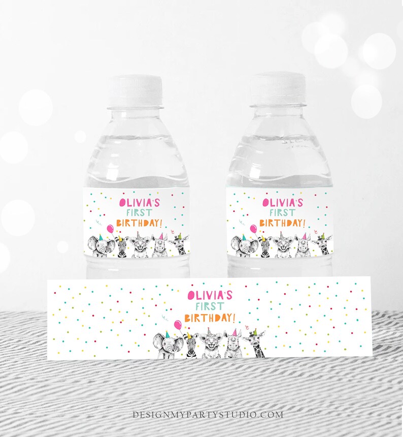 May include: Water bottle labels with a colorful polka dot background and a black and white illustration of animals wearing party hats. The text on the label reads "Olivia's First Birthday!"