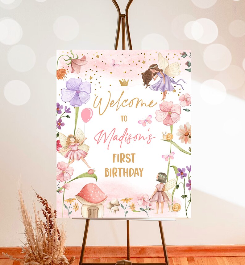 May include: Welcome to Madison's First Birthday sign with a pink and white background featuring fairies, flowers, and a mushroom house. The sign is perfect for a fairy-themed birthday party.