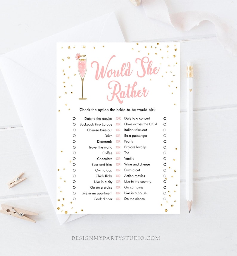 May include: A pink and gold bridal shower game with the text "Would She Rather" and a list of questions for guests to answer. The game features a pink champagne glass with a gold rim and a pink flower.