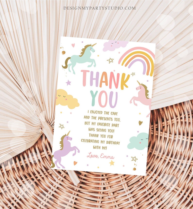 May include: A thank you card with a unicorn theme. The card features a rainbow, clouds, stars, and unicorns. The text on the card reads "Thank You" and "I enjoyed the cake and the presents too, but my favorite part was seeing you! Thank you for celebrating my birthday with me! Love, Emma."