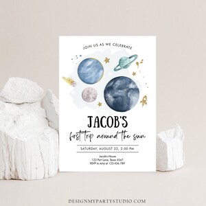 May include: A blue and white invitation with a watercolor illustration of planets and stars. The text reads "Join us as we celebrate Jacob's first trip around the sun. Saturday, August 22, 2:00 PM. Jacob's House, 123 Part Lane, Texas 4567. RSVP to Amy at 123.456.789. DesignMyPartyStudio.com"