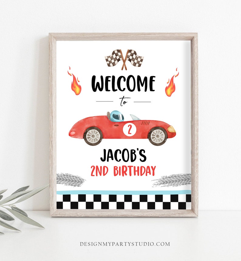 May include: A printable welcome sign for a 2nd birthday party with a red race car, checkered flags, and flames. The sign says "Welcome to Jacob's 2nd Birthday".