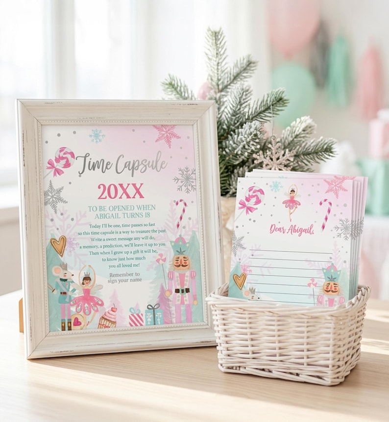 May include: A white distressed frame containing a Time Capsule sign with pink and blue holiday graphics, including a nutcracker and ballerina. Next to it is a white woven basket holding a stack of lined stationery cards labeled Dear Abigail.