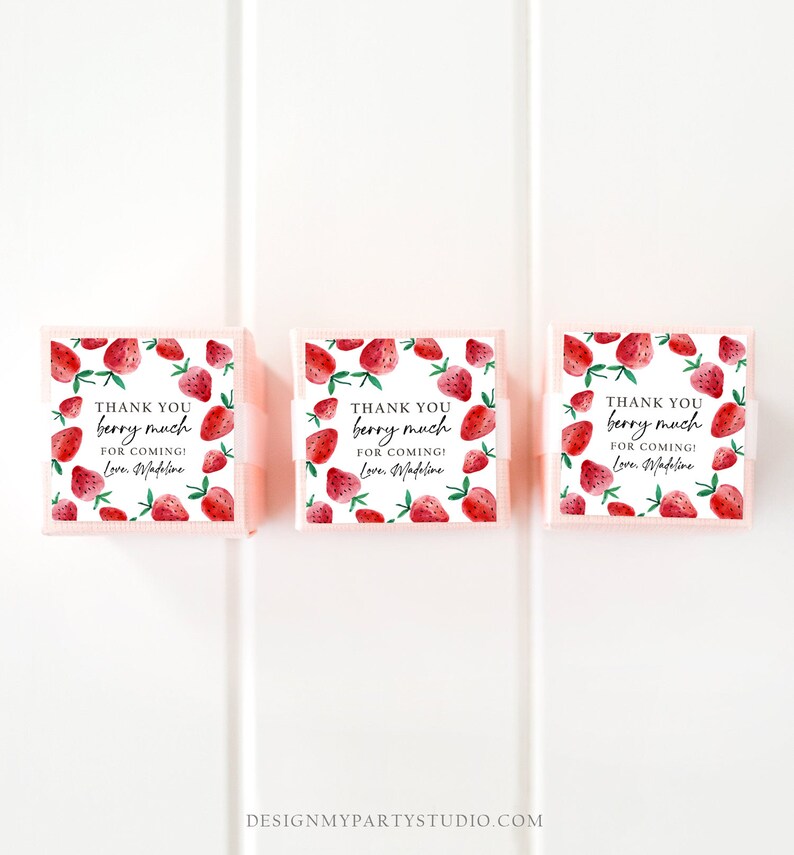 May include: Three small pink boxes with white lids and a strawberry pattern. Each box has a white ribbon and a thank you tag that reads "Thank you berry much for coming! Love, Madeline".