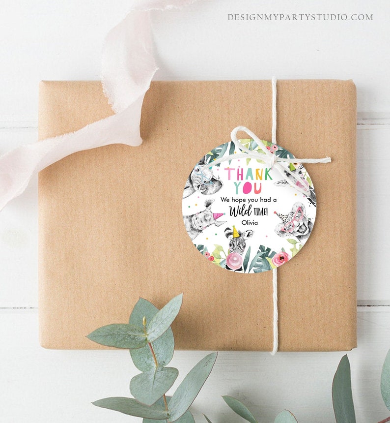 May include: A gift wrapped in brown paper with a white string and a round tag. The tag features a watercolor design with the words "THANK YOU" and "We hope you had a Wild time!" along with animal illustrations.