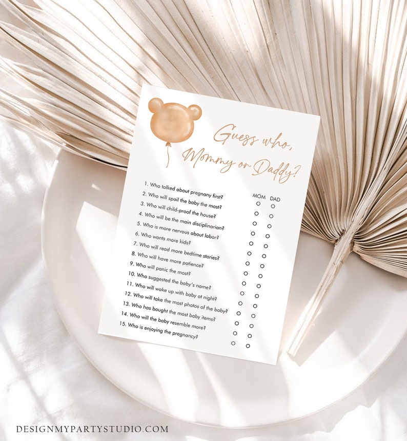 May include: A printable baby shower game card with the text "Guess who, Mommy or Daddy?" and a list of 15 questions about pregnancy and parenting.  Each question has two circles next to it, labeled "Mom" and "Dad".