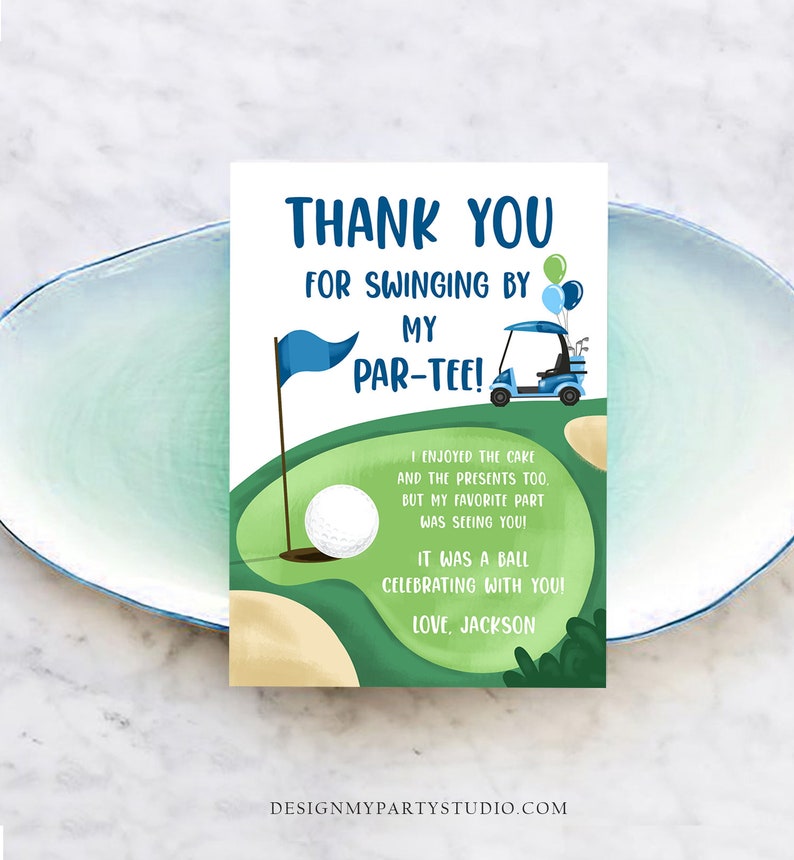 May include: A golf-themed thank you card with the text "THANK YOU FOR SWINGING BY MY PAR-TEE!". The card features a golf course illustration with a golf ball, flag, and golf cart. The text "I enjoyed the cake and the presents too, but my favorite part was seeing you! It was a ball celebrating with you! Love, Jackson."