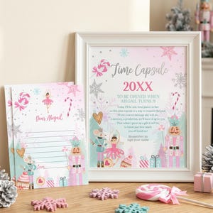 May include: A white framed sign and matching stationery featuring a pink and blue winter theme with nutcracker, ballerina, and candy illustrations. The text reads Time Capsule 20XX, To be opened when Abigail turns 18, and Dear Abigail with lines.