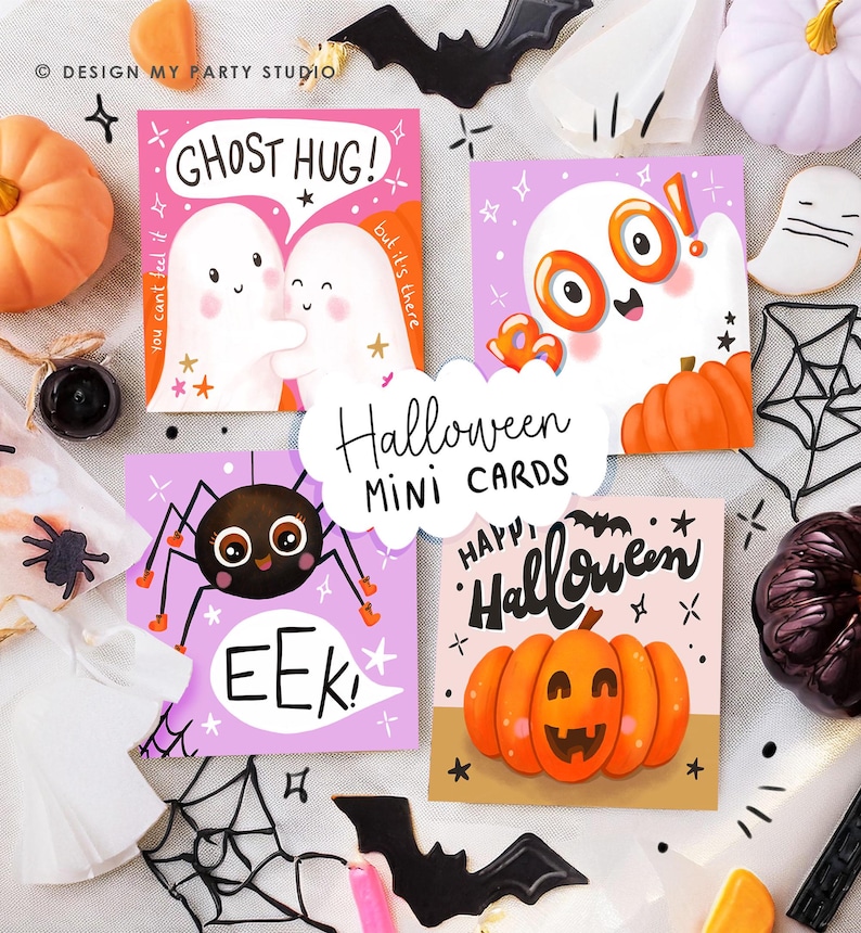 May include: A collection of Halloween mini cards with various designs. One card features two ghosts hugging with the text "Ghost Hug!". Another shows a spider with the word "EEK!". A third card has a pumpkin with the words "Happy Halloween". The cards are surrounded by Halloween decorations.