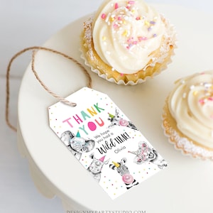 May include: Thank you tag with a white background and colourful polka dots. The tag features a cartoon illustration of animals wearing party hats. The text reads "Thank You" in colourful letters and "We hope you had a Wild Time!" with the name "Olivia" below.