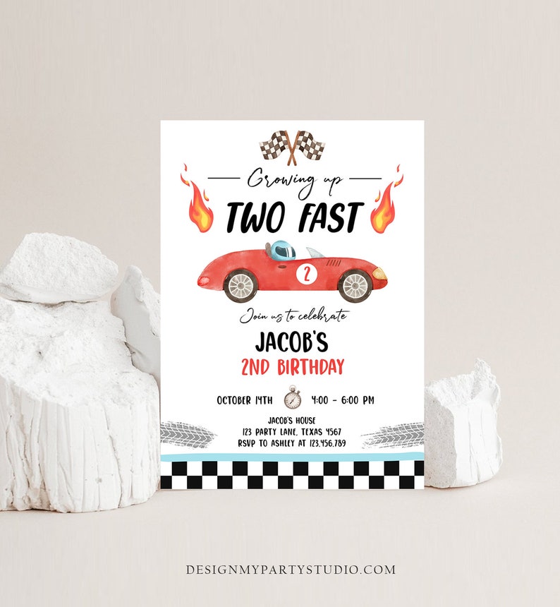 May include: A red race car with a checkered flag and flames on either side. The text "Growing up TWO FAST" is above the car. The text "Join us to celebrate JACOB'S 2ND BIRTHDAY" is below the car. The text "OCTOBER 17TH 4:00 - 6:00 PM JACOB'S HOUSE 123 PARTY LANE, TEXAS 4567 RSVP TO ASHLEY AT 123.456.789" is below the car. The text "DESIGNMYPARTYSTUDIO.COM" is at the bottom of the invitation.
