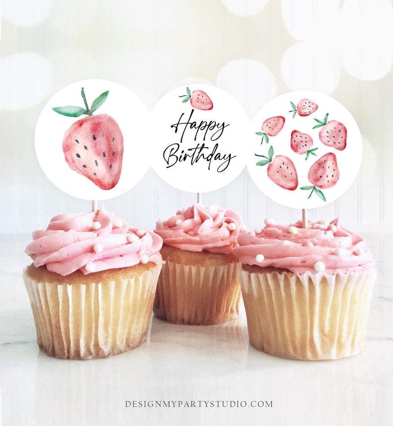 May include: Three cupcake toppers with a watercolor strawberry design. One topper says "Happy Birthday" in black script. The other two toppers feature a single strawberry and a cluster of strawberries.