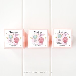 May include: Three pink boxes with thank you tags. The tags feature a watercolor illustration of planets and stars with gold glitter accents. The text on the tags reads "Thank you for making my party a BLAST Love, Stella".