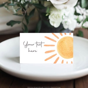 May include: A white card with a watercolor illustration of a sun with orange rays. The text "Your text here" is written in black cursive on the left side of the card.