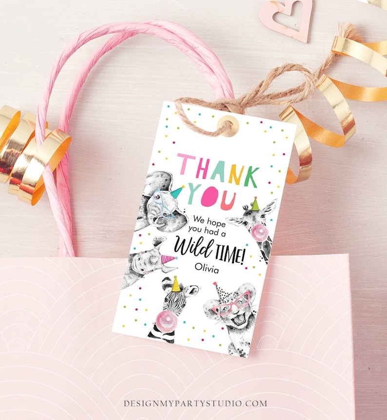 May include: Thank you tag with colourful text that says "Thank You" and "We hope you had a Wild Time!" with a giraffe, elephant, and zebra wearing party hats. The tag is white with colourful confetti and the name "Olivia" is printed below the text.