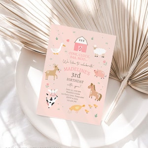 May include: Pink and green farm animal themed birthday invitation with a pink barn, a cow, a pig, a horse, a sheep, a deer, a duck, and a chicken. The text reads "Oink, Cluck, BAA, MOO... We like to celebrate MADELINE'S 3rd BIRTHDAY with you! June 22, 2:00 pm Madelin's Farm 123 Party Lane, Texas 4567 RSVP to Amy 123.456.789"