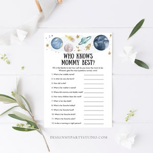 May include: A printable baby shower game with a space theme. The game is called "Who Knows Mommy Best?" and asks guests to fill in the blanks about the mum-to-be. The game features a watercolour illustration of planets, stars, and a rocket ship.
