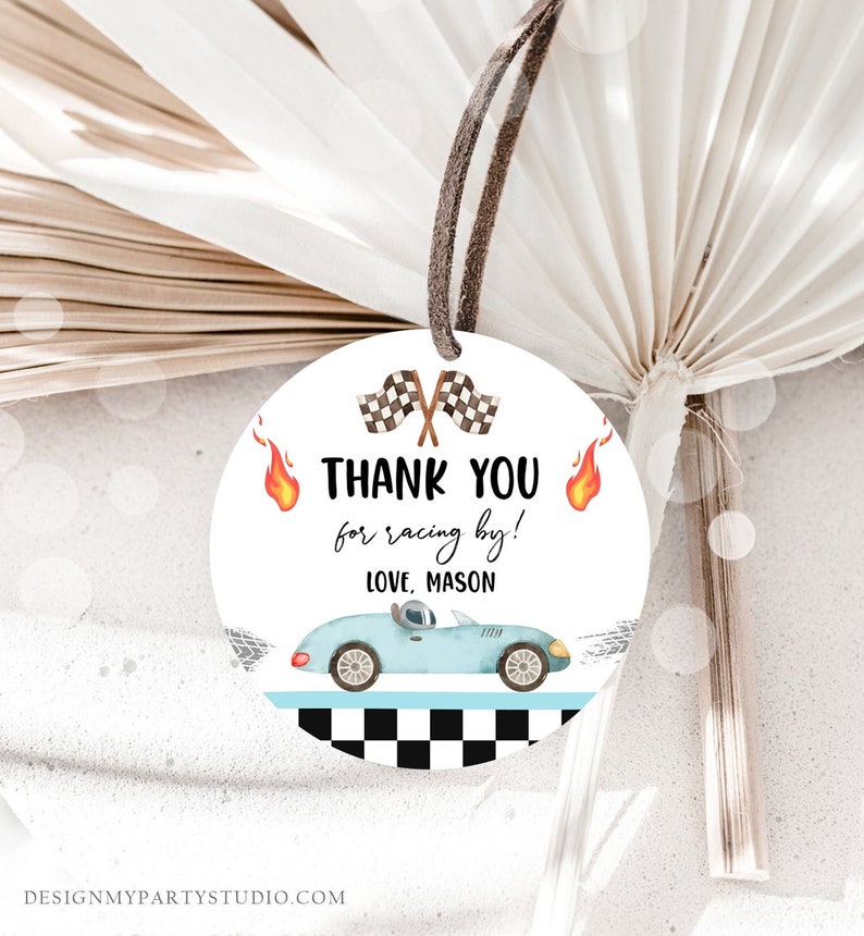May include: Round thank you tag with a blue race car, checkered flag, and flames. The text reads "Thank you for racing by! Love, Mason".