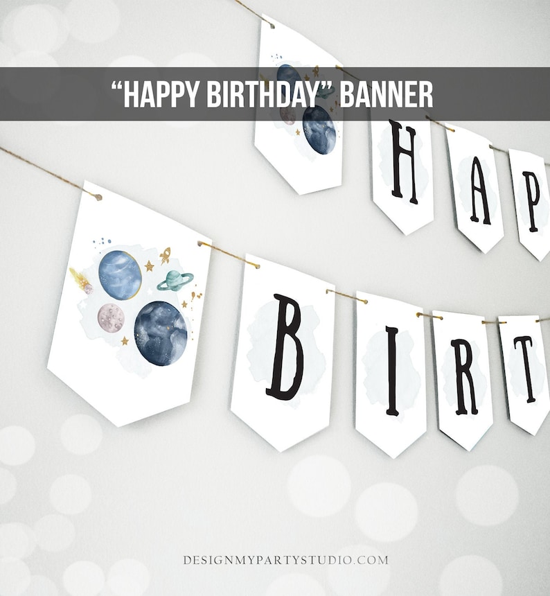 May include: A white banner with the words "Happy Birthday" in black letters. The banner is decorated with blue, pink, and gold planets and stars. The banner is strung on a twine string.