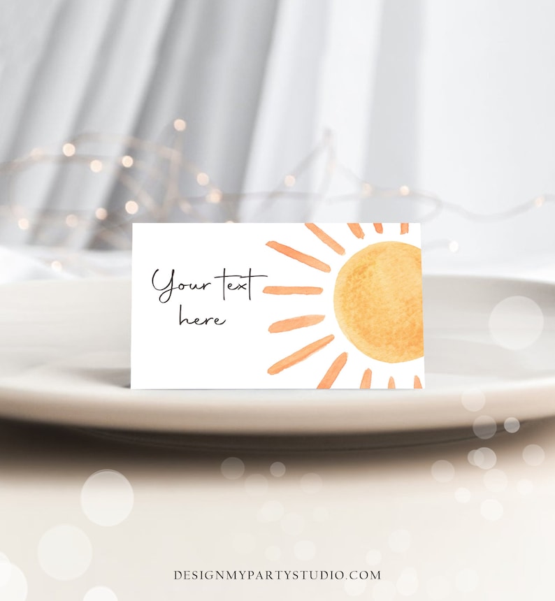 May include: A white card with a watercolor illustration of a sun with orange rays. The text "Your text here" is written in black cursive.