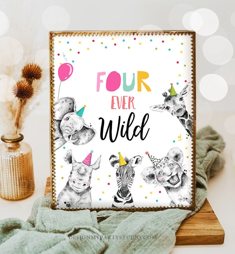 May include: A white sign with a gold frame and colorful confetti dots. The sign says "Four Ever Wild" in black and pink lettering. There are four animals peeking out from behind the sign: an elephant, a giraffe, a rhinoceros, and a zebra. Each animal is wearing a party hat.