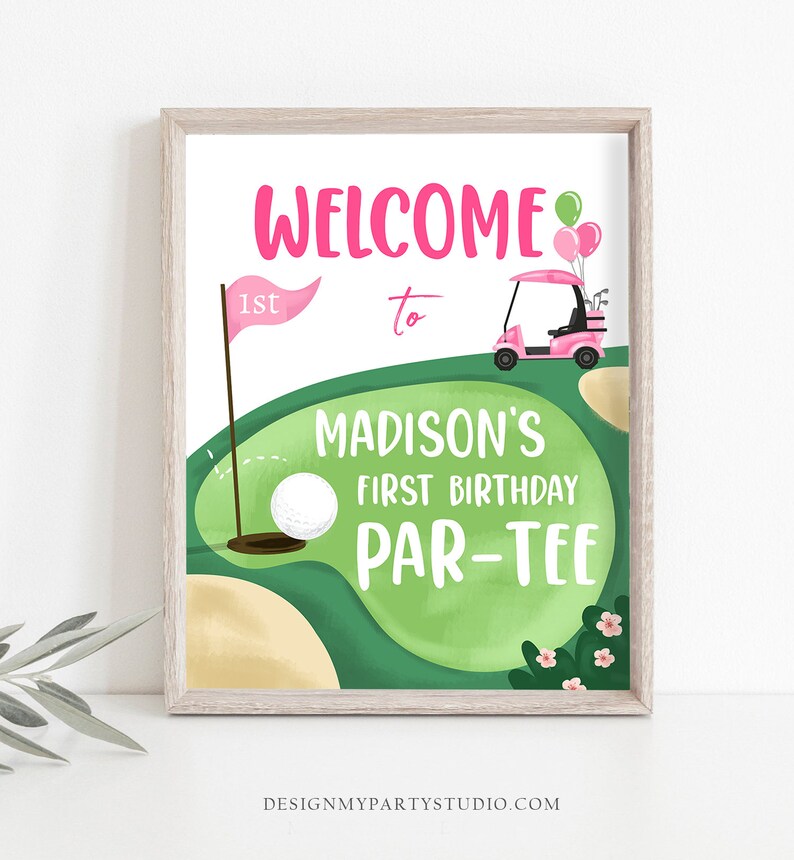 May include: A pink and green golf-themed birthday party sign with the text "Welcome to Madison's First Birthday Par-Tee".
