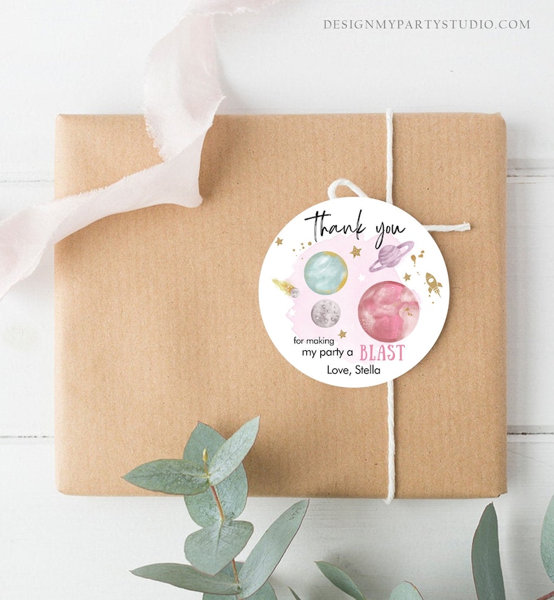 May include: Round thank you tag with a pink, blue, and gray watercolor galaxy design. The tag says "Thank you for making my party a BLAST. Love, Stella."