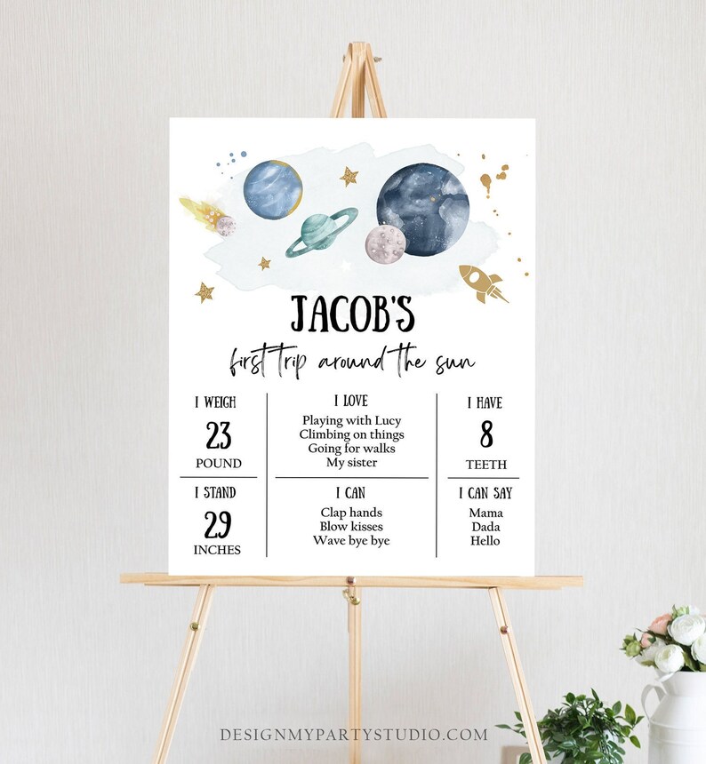 May include: A blue and white printable sign with a space theme. The sign says "Jacob's first trip around the sun". It includes details about Jacob's age, weight, and what he can do.