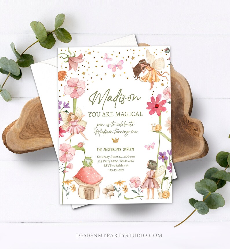 May include: A white invitation card with a floral design featuring fairies, butterflies, and mushrooms. The text on the card reads "Madison You Are Magical join us to celebrate Madison turning one The Anderson's Garden Saturday, June 22, 2:00 pm 123 Party Lane, Texas 4567 RSVP to Ashley at 123.456.789 DESIGNMYPARTYSTUDIO.COM"