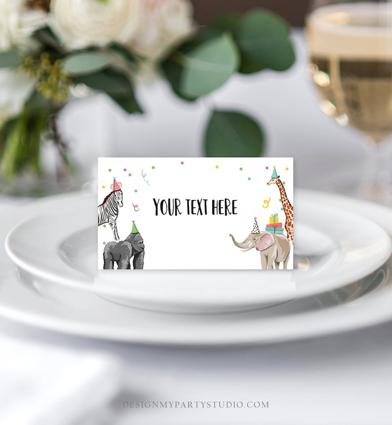 May include: A white place card with a colorful confetti border and a zebra, gorilla, elephant, and giraffe wearing party hats. The text "YOUR TEXT HERE" is in the center of the card.