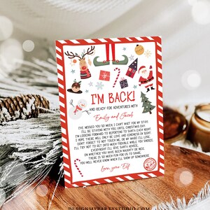 May include: A festive Christmas card with a red and white border, featuring holiday illustrations of a reindeer, elf shoes, Santa, and a snowman. The card reads "I'm Back!" and includes a personalized message.