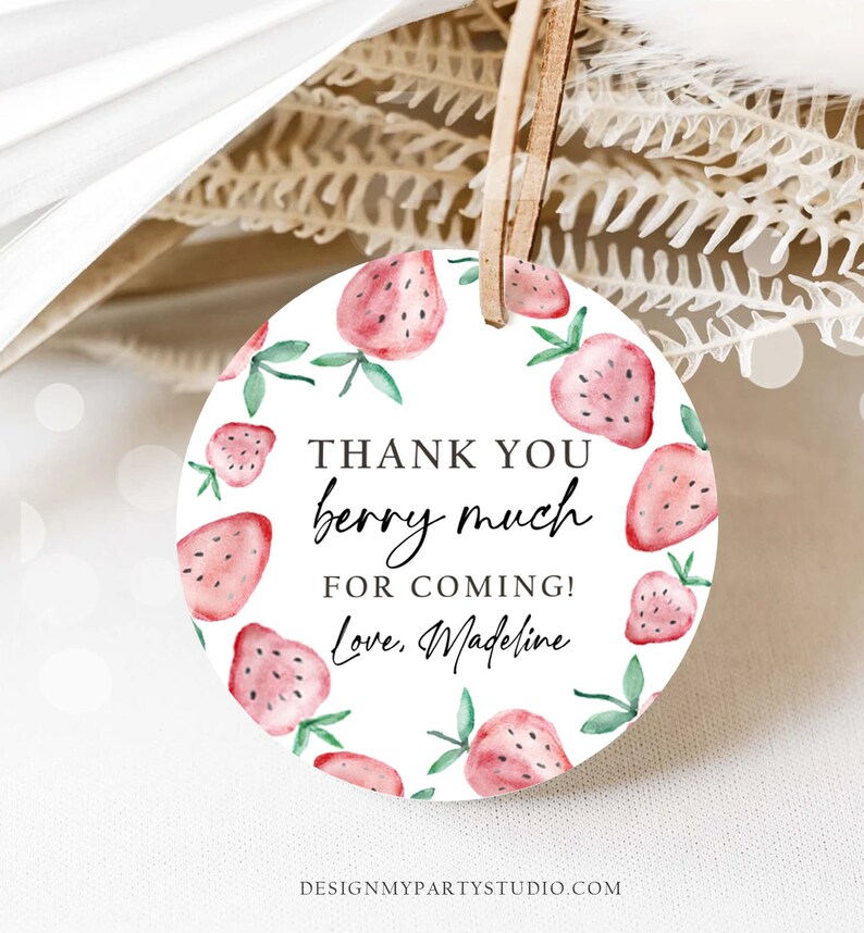 May include: Round white thank you tag with a red and green watercolor strawberry design. The text reads "Thank you berry much for coming! Love, Madeline".