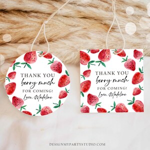 May include: Two round thank you tags with a white background and red strawberries with green leaves. The text on the tags reads "Thank you berry much for coming! Love, Madeline".