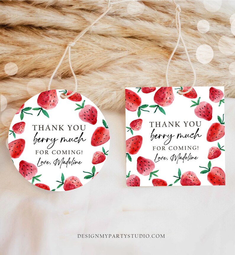 May include: Two round thank you tags with a white background and red strawberries with green leaves. The text on the tags reads "Thank you berry much for coming! Love, Madeline".