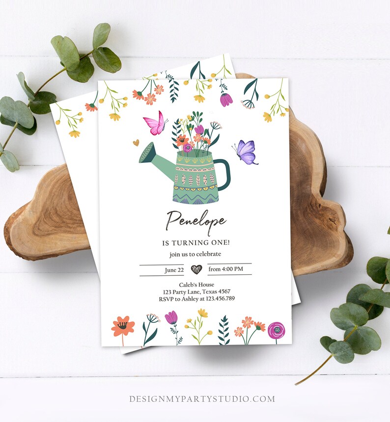 May include: A green watering can with a colorful floral arrangement and butterflies. The text "Penelope is turning one!" is written on the card. The card also includes the date, time, and location of the event.
