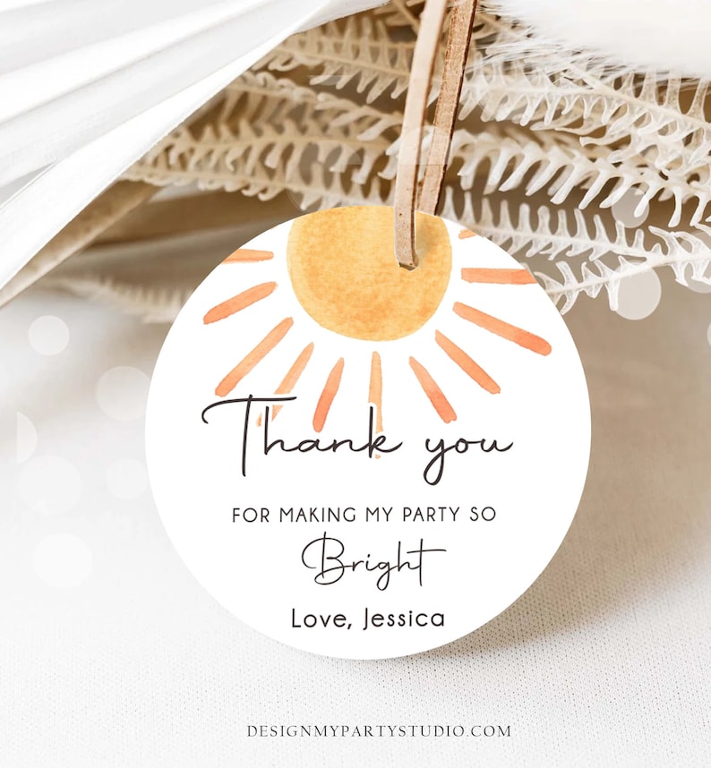 May include: Round thank you tag with a watercolor sun design. The tag says "Thank you for making my party so Bright. Love, Jessica".