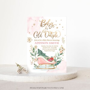 May include: A baby shower invitation with a pink and gold design. The text "Baby it's Cold Outside" is in gold script. A pink sleigh with gifts and a Christmas tree is featured. The invitation includes the name Addison Smith and event details.
