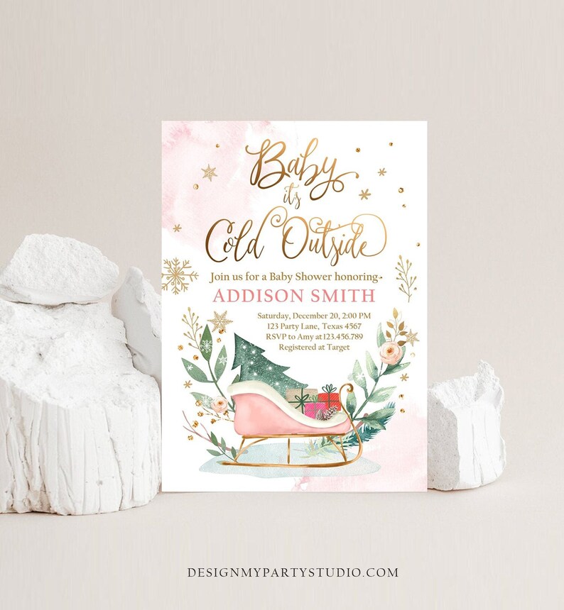 May include: A baby shower invitation with the text "Baby it's Cold Outside" in gold script. The invitation features a pink watercolor background, snowflakes, and a sleigh with gifts. The invitation is for Addison Smith.