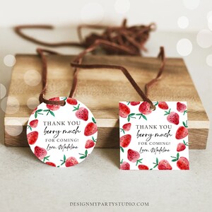 May include: Two round and rectangular thank you tags with a strawberry design. The text on the tags reads "Thank you berry much for coming! Love, Madeline".