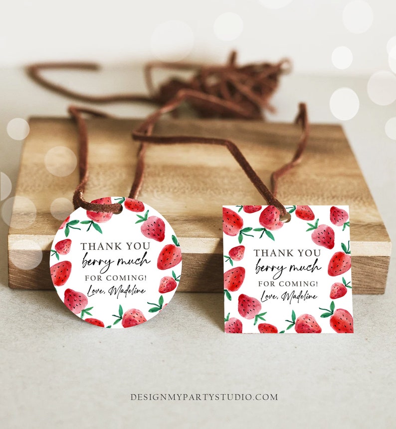 May include: Two round and rectangular thank you tags with a strawberry design. The text on the tags reads "Thank you berry much for coming! Love, Madeline".