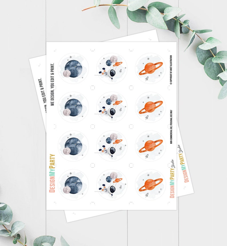 May include: A sheet of circular stickers featuring watercolor illustrations of planets, rockets, and stars. The designs include planets with rings, Earth-like planets, and astronaut-themed elements. The text "DESIGNMYPARTY" is visible on the bottom left.
