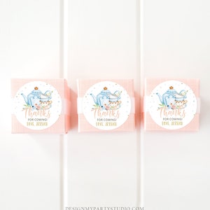 May include: Three pink favour boxes with white ribbon and round stickers. The stickers feature a blue teapot, teacups, and a bear with pink flowers. The text on the stickers reads "Thanks for coming! Love, Jessica."