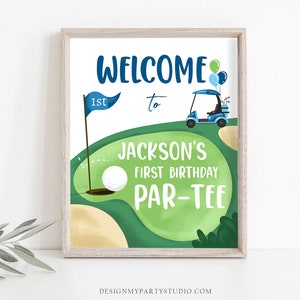 May include: A green and brown golf course with a blue golf cart, a golf ball, and a flag with the number "1st" on it. The text "Welcome to Jackson's First Birthday Par-Tee" is written on the sign.