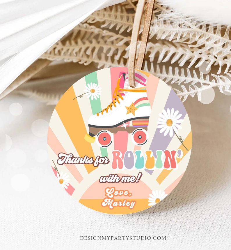 May include: A round, colorful thank you tag with a retro roller skate design. The tag features a white roller skate with rainbow accents and a yellow star. The text on the tag reads "Thanks for rollin' with me! Love, Marley".