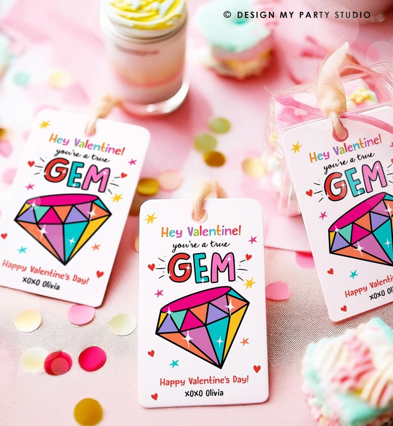 May include: Three colourful Valentine's Day gift tags with a diamond design and the text "Hey Valentine! You're a true GEM."  Each tag has the text "Happy Valentine's Day! XOXO Olivia" at the bottom.