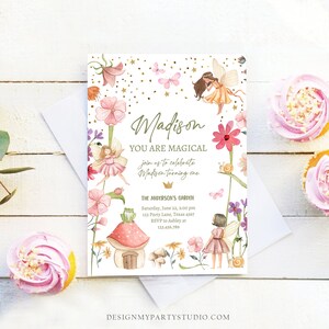 May include: A whimsical fairy-themed first birthday party invitation with a watercolor illustration of fairies, flowers, butterflies, and a mushroom house. The invitation reads "Madison You Are Magical join us to celebrate Madison turning one The Anderson's Garden Saturday, June 22, 2:00 pm 123 Party Lane, Texas 4567 RSVP to Ashley at 123-456-789".