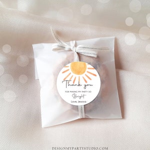 May include: A round thank you tag with a watercolour sun design. The tag says "Thank you for making my party so Bright. Love, Jessica."