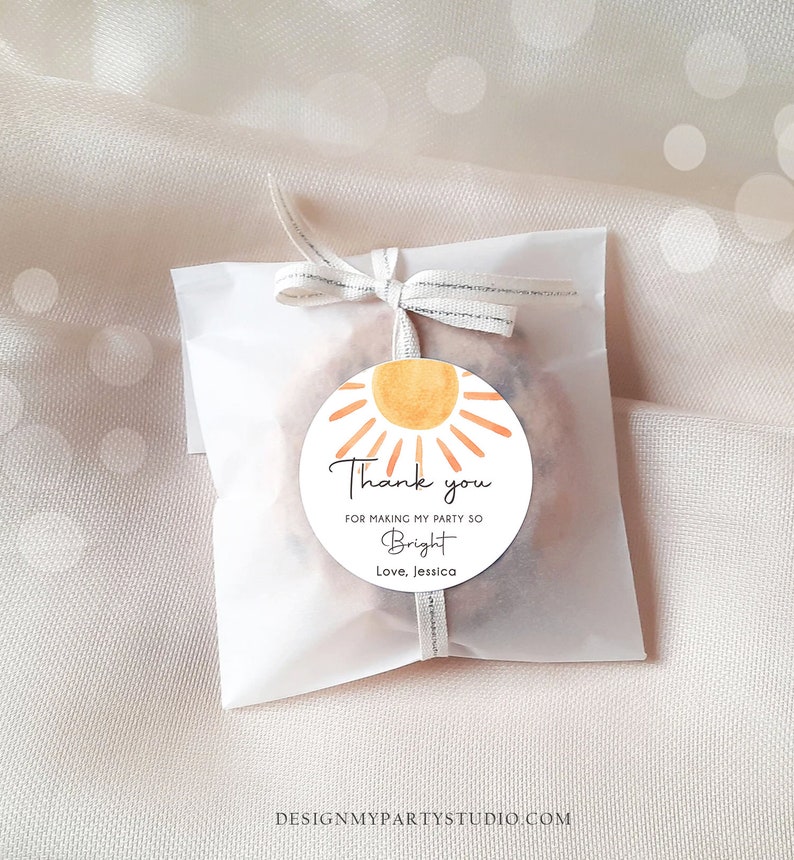 May include: A round thank you tag with a watercolour sun design. The tag says "Thank you for making my party so Bright. Love, Jessica."